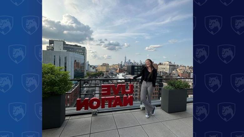 Woman standing on roof with Live Nation sign in red